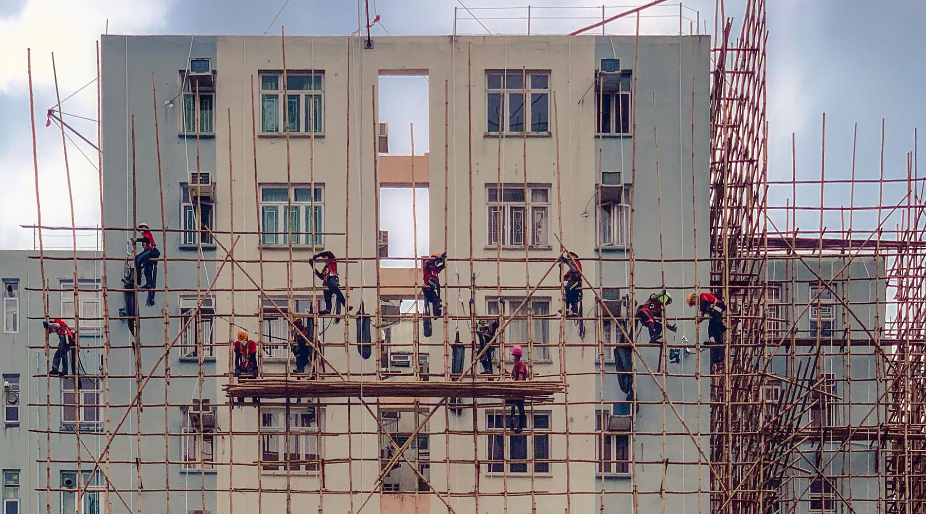 Construction workers on a multi-story building project