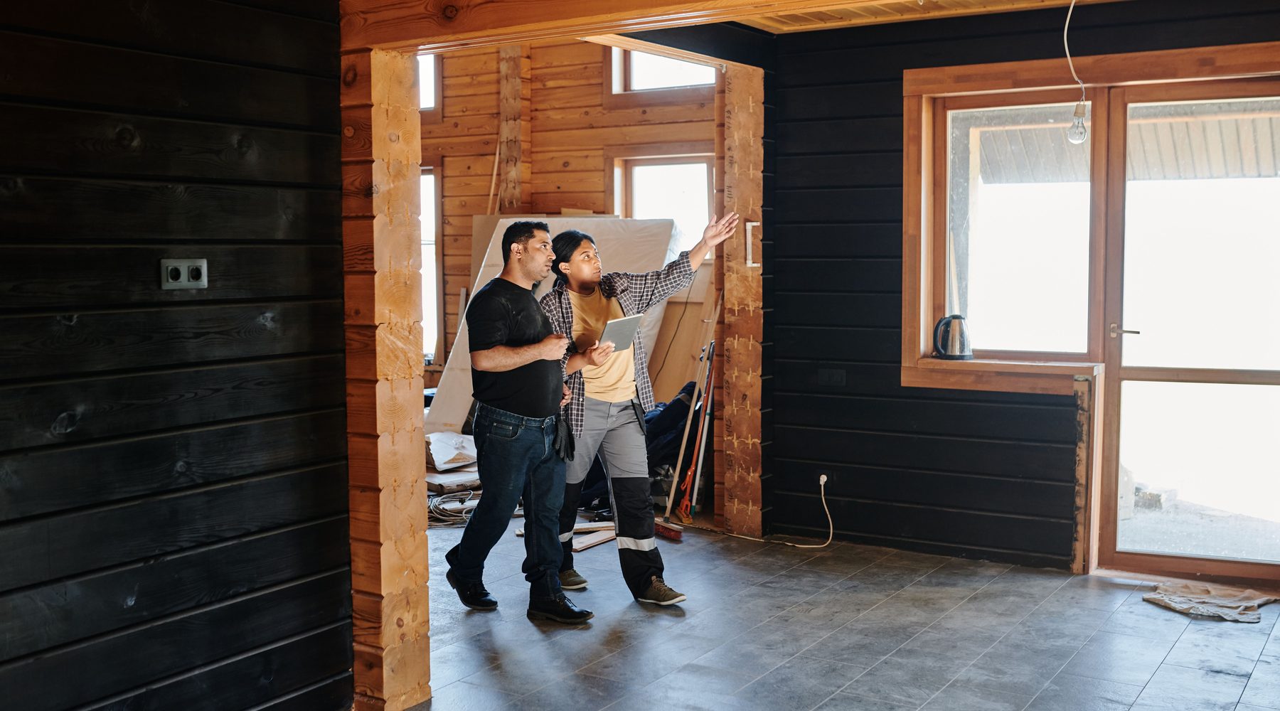 Construction professionals discussing work during an interior walkthrough