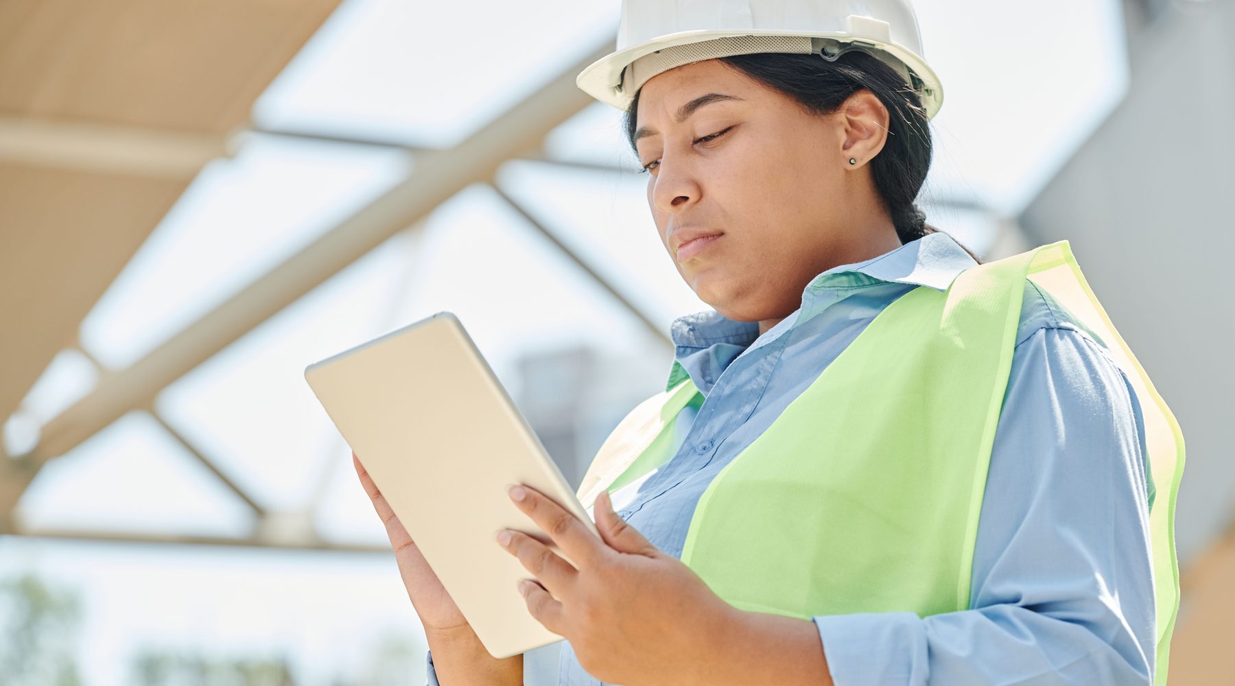 Construction professional reviewing project information on a tablet