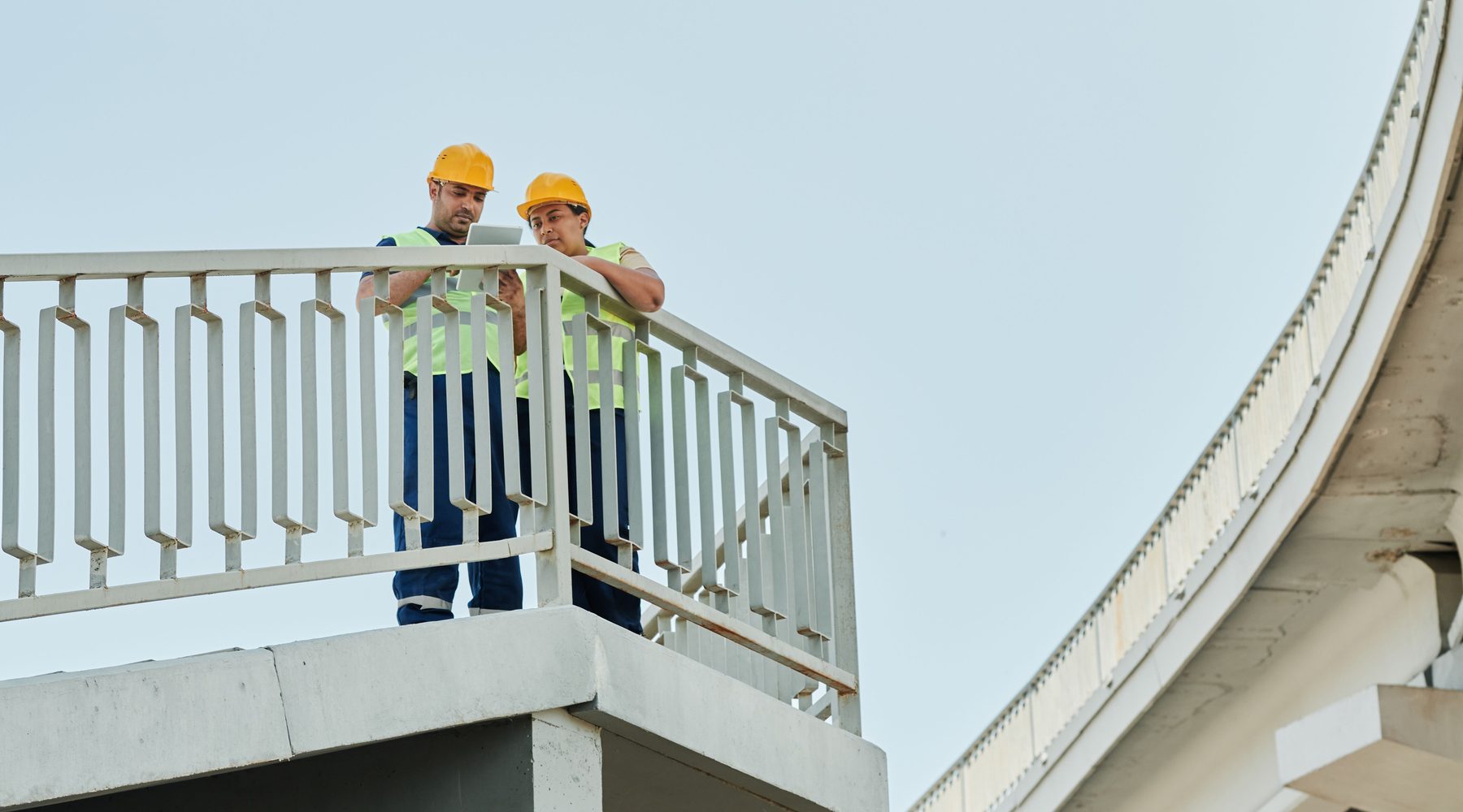 Construction professionals inspecting an elevated structure